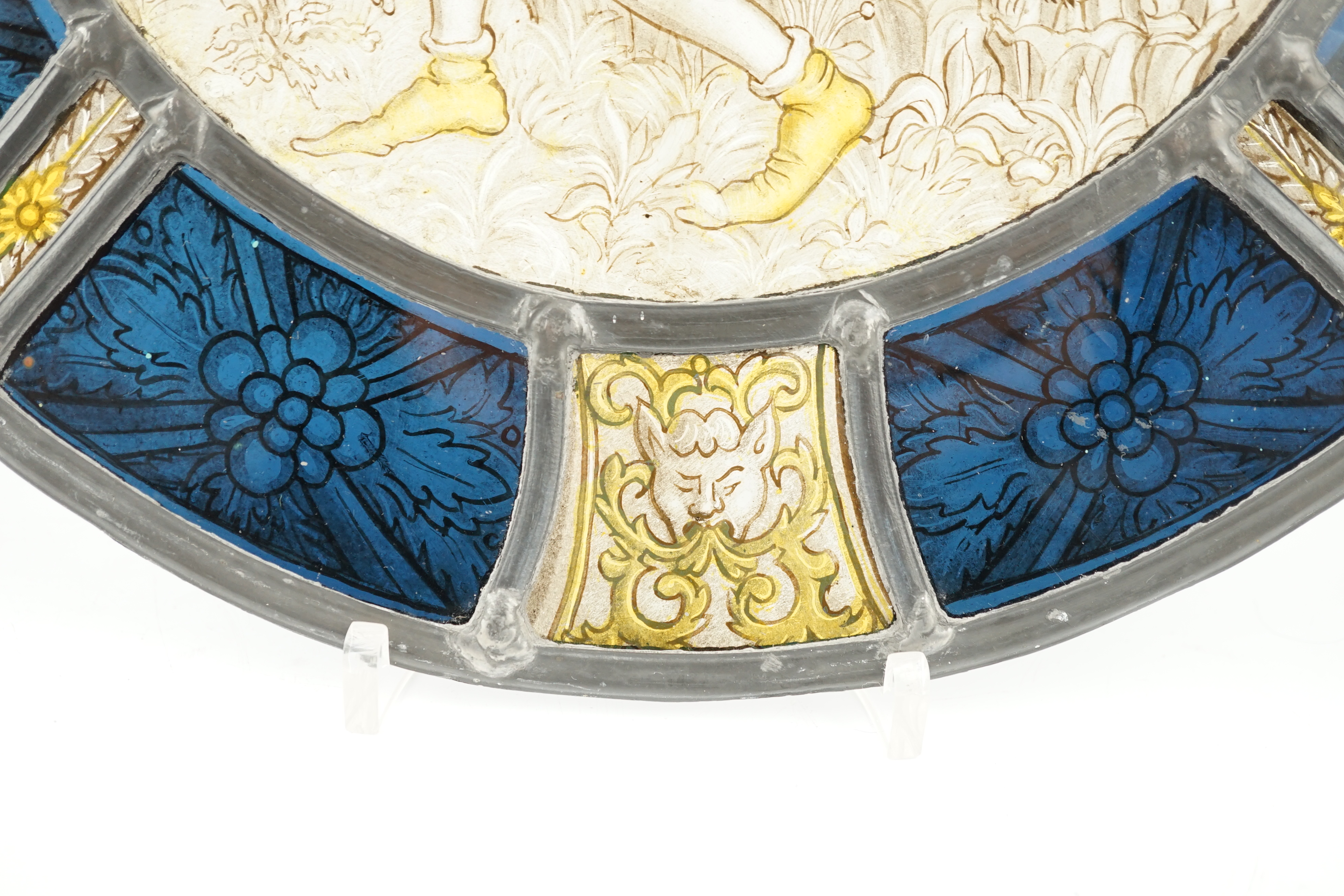 An 18th century Flemish stained glass panel, 32cm diameter